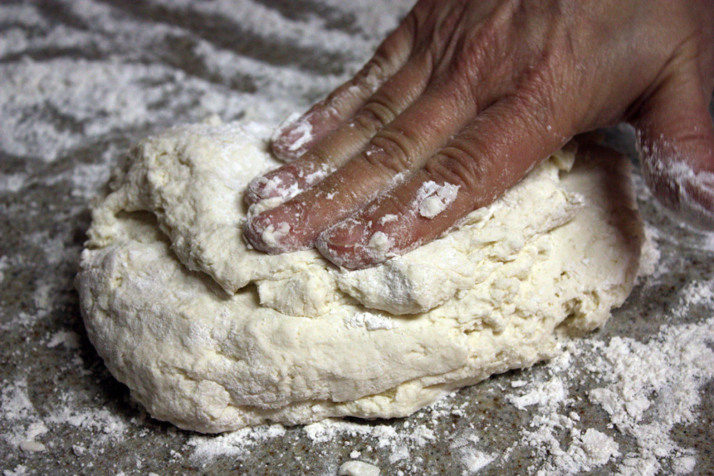 Southern buttermilk biscuit dough on a floured surface.