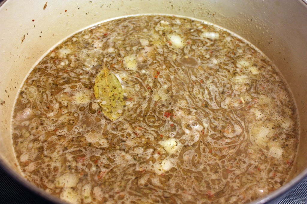 Sausage Potato and Kale Soup ingredients in a dutch oven.