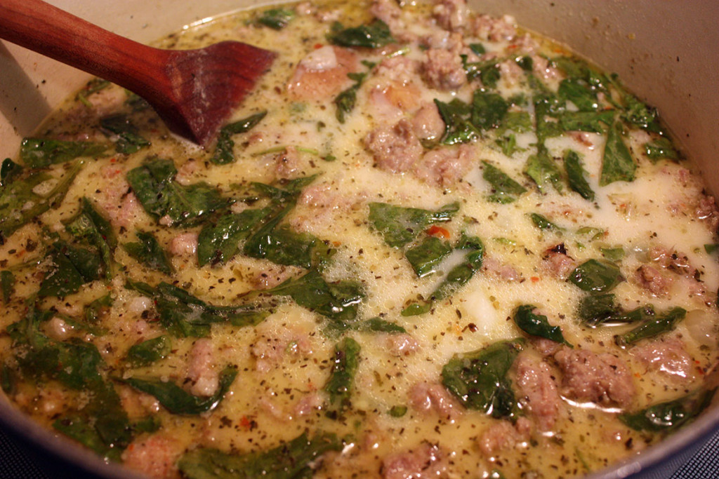 Sausage Potato and Kale Soup in a dutch oven.