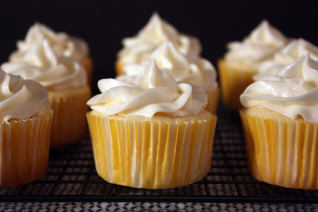 Lemon cupcakes on a wire rack.