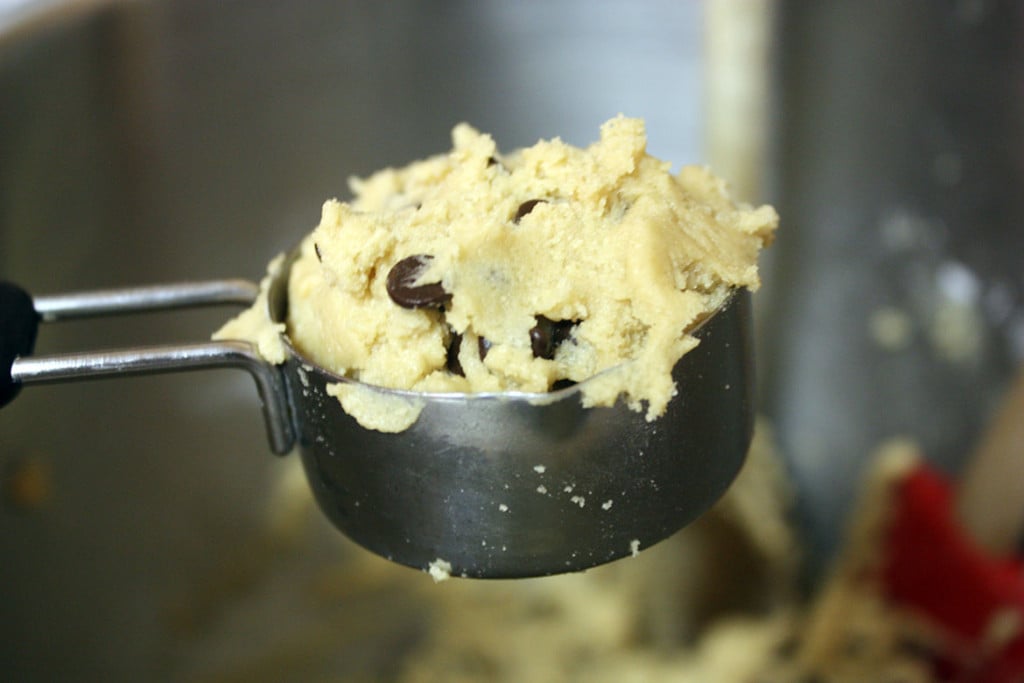 Cookie dough in a dry measuring cup.