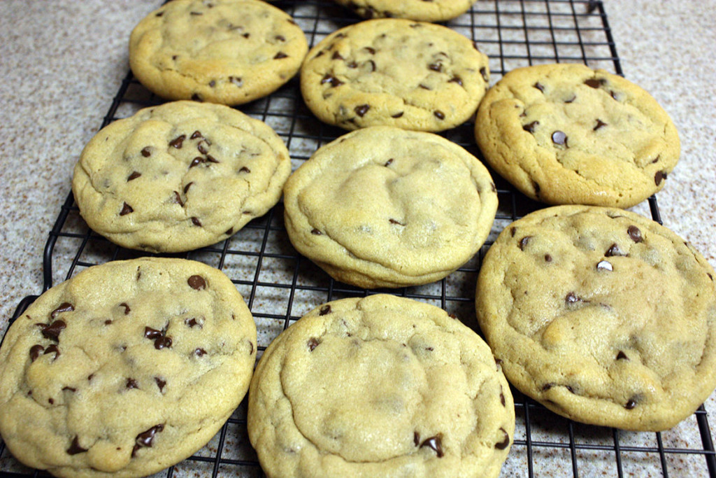 Large chewy chocolate chip cookies on a wire rack.