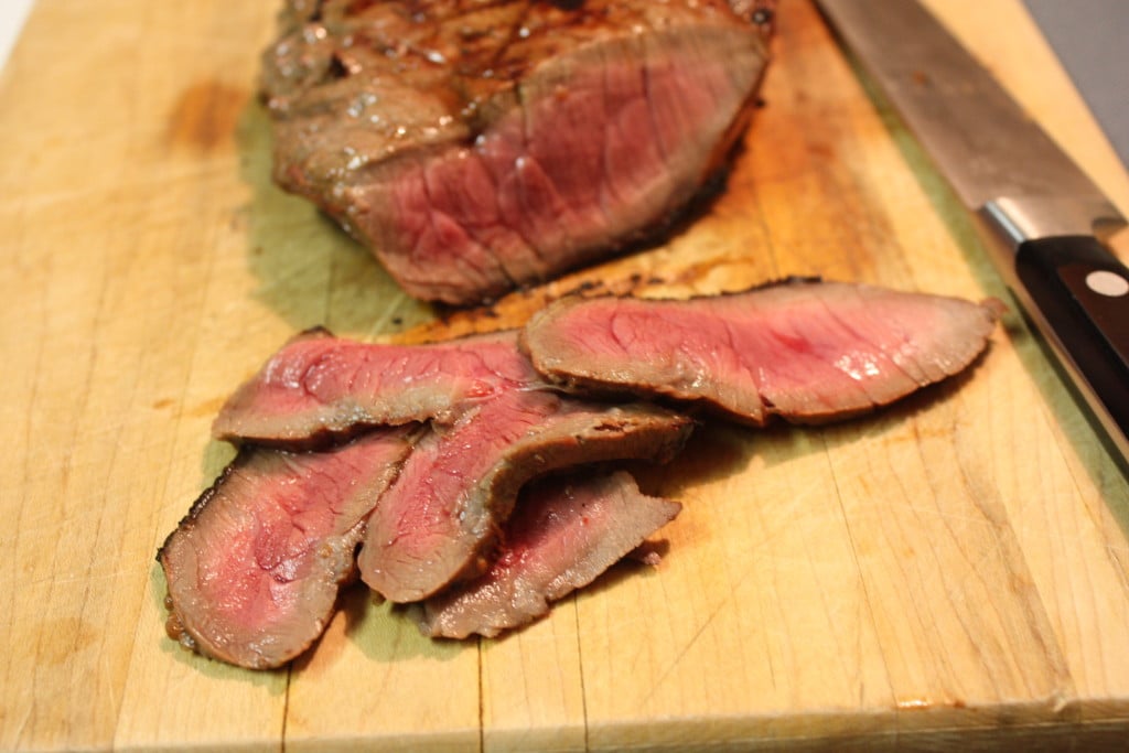 London Broil sliced on a board