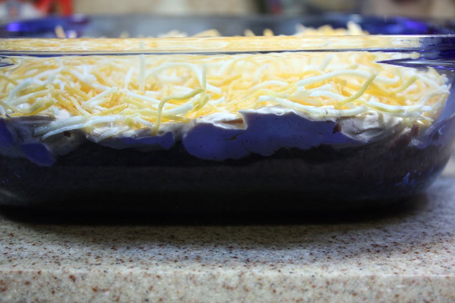 Ingredients layered in a blue baking dish.