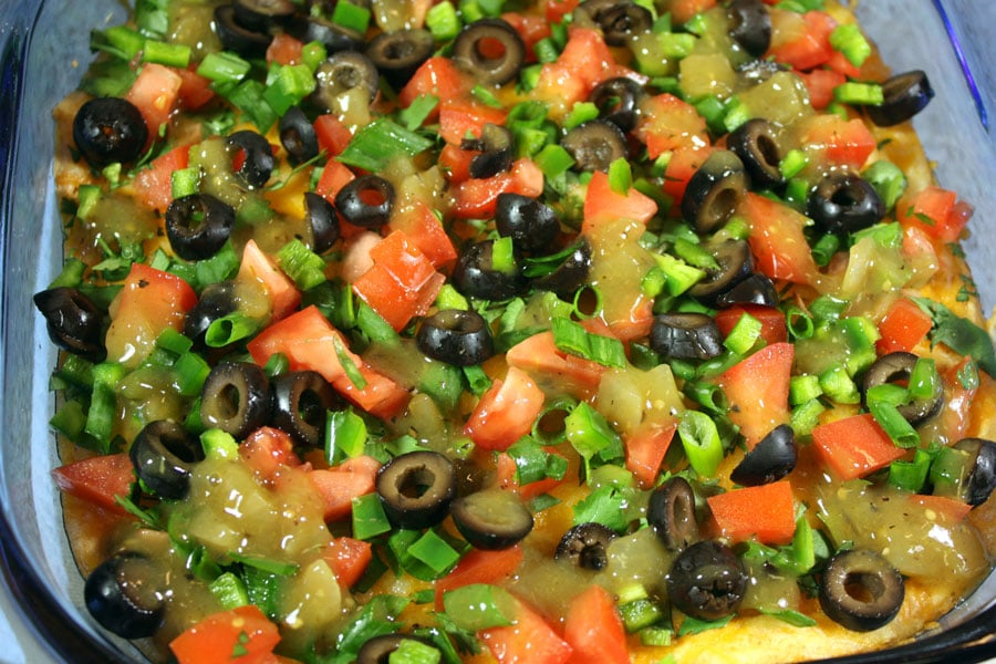Black Bean Taco Dip with the toppings sprinkled over the topped.