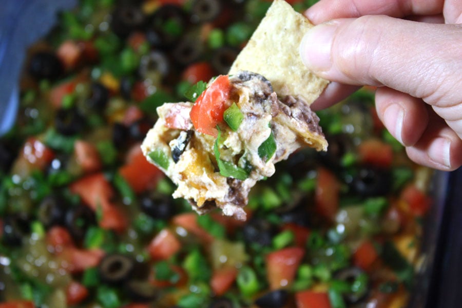 Black Bean Taco Dip scooped on a tortilla chip.