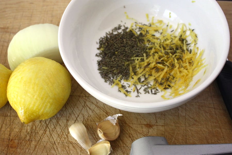 Lemon zest and thyme in a white bowl