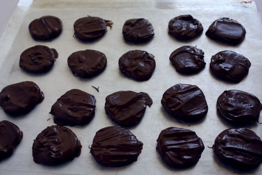 Thin Mint Cookies dipped in chocolate placed on wax paper.