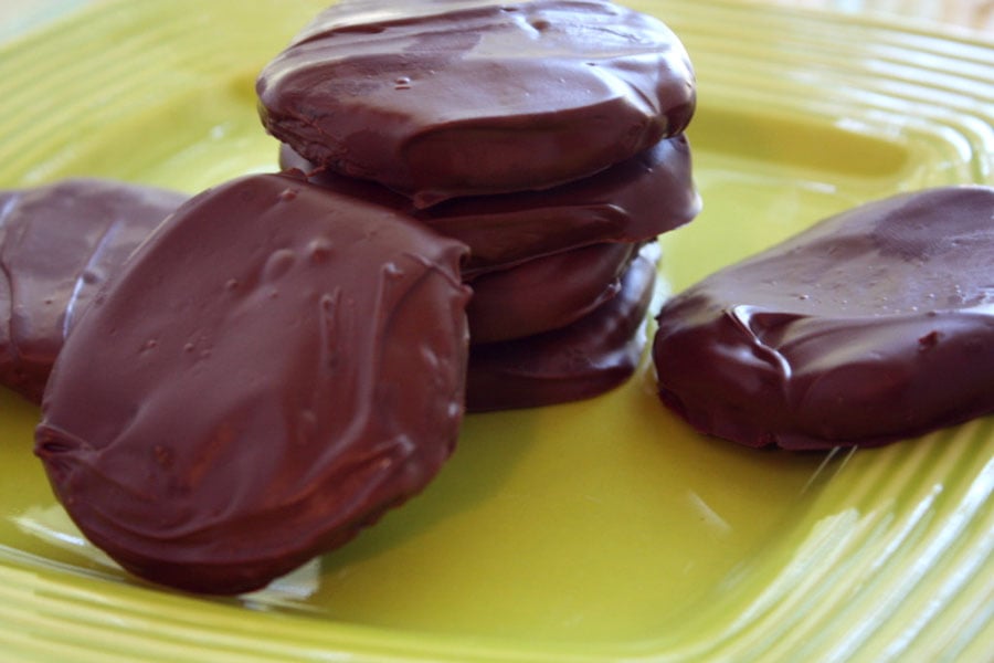 Thin Mint Cookies stacked on a green plate.