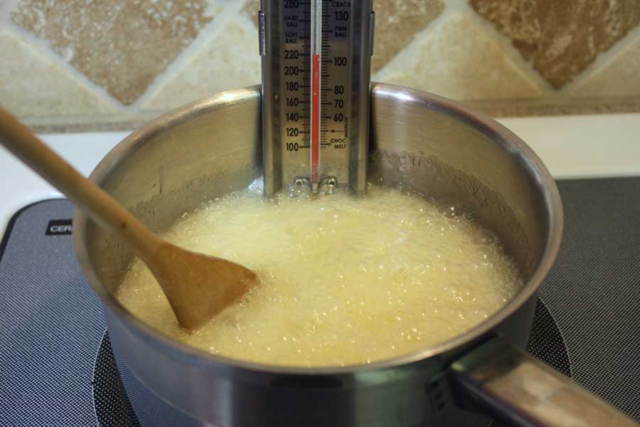 Ingredients for candy in a saucepan boiling.