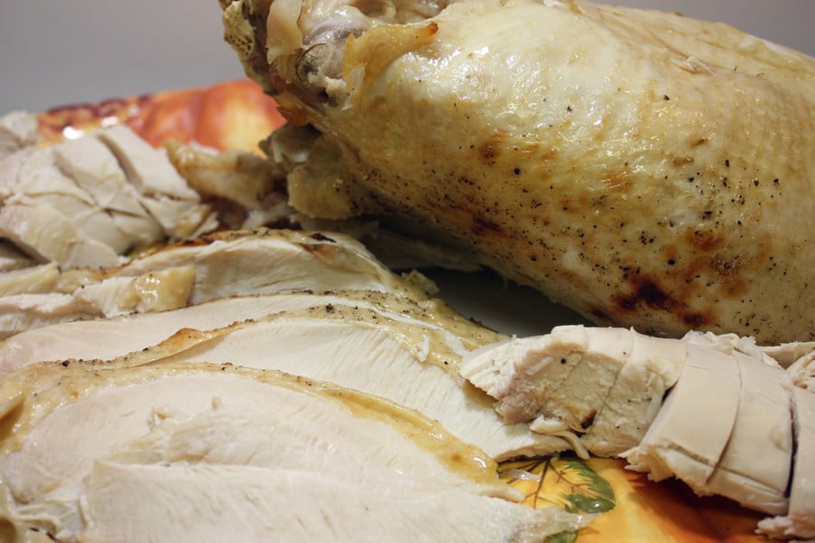 sliced turkey breast on a pumpkin platter