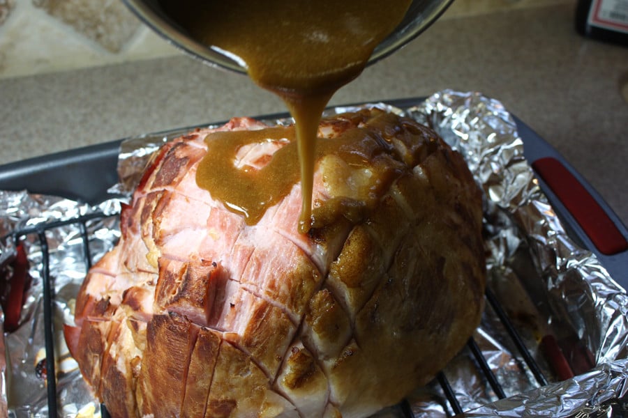 Glaze being poured over ham.
