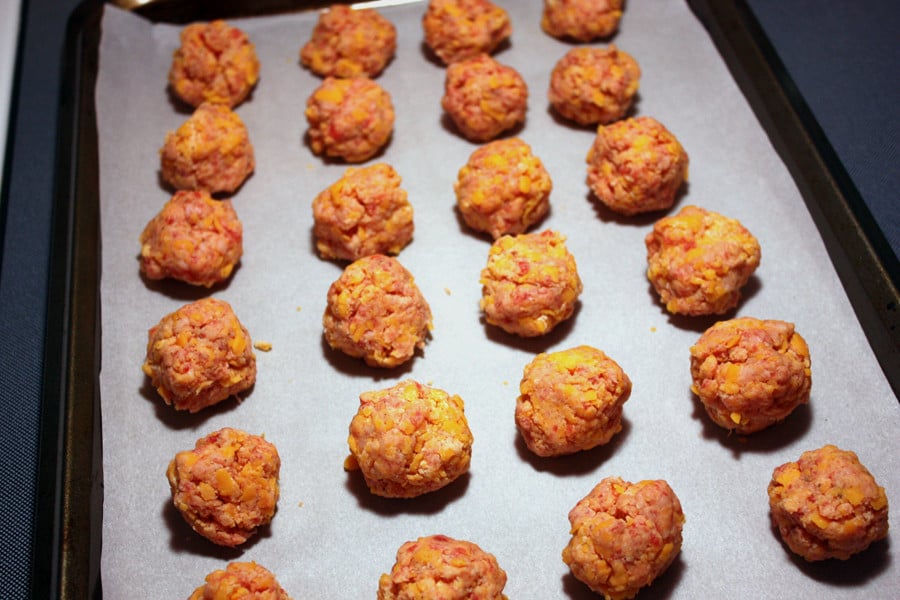 Sausage Balls formed and placed on a parchment paper lined baking sheet