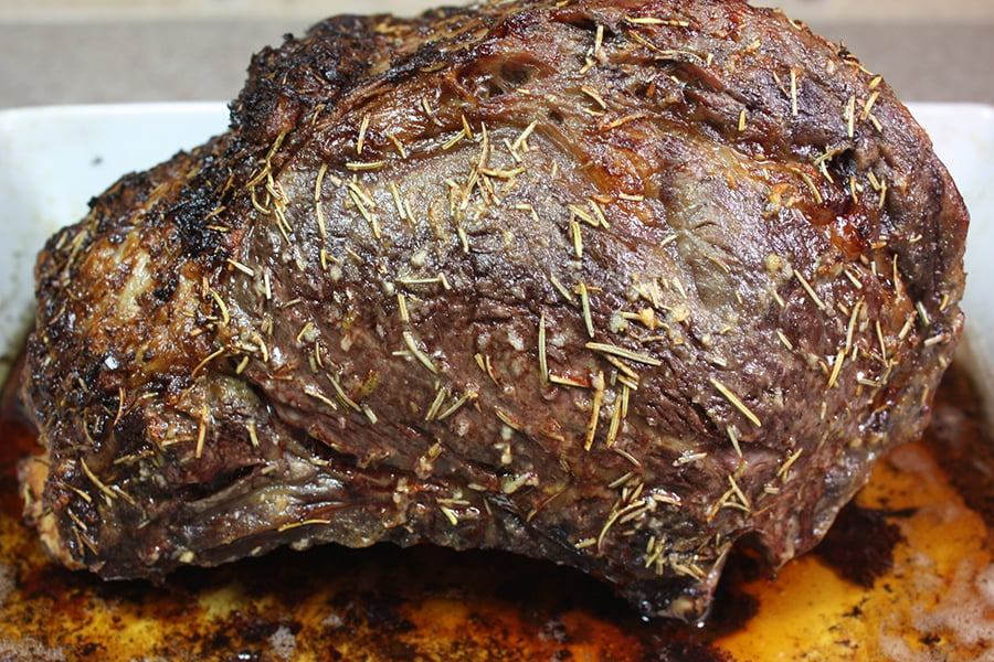 Prime Rib cooked in a white baking dish.