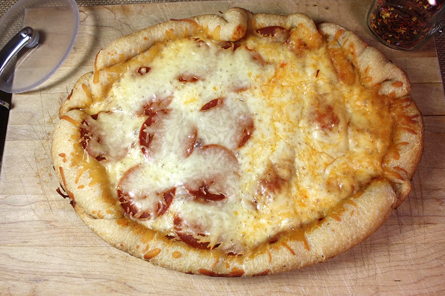 Slow Cooker Pizza on a wooden cutting board