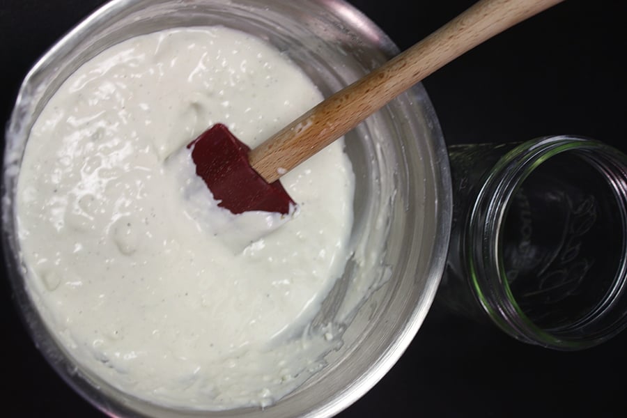Blue Cheese Dressing mixed in a metal bowl with a spatula.