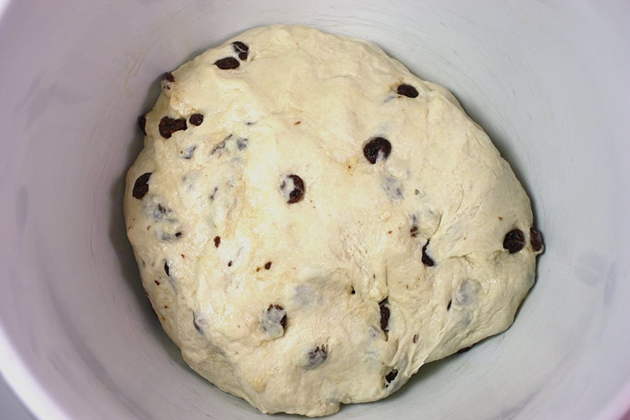 Bread dough in a white bowl.