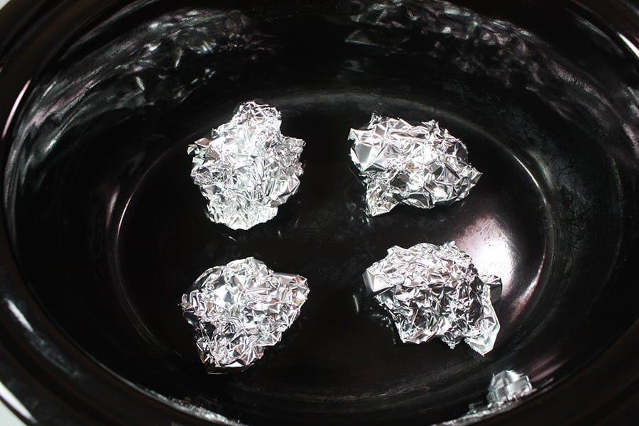 Slow Cooker Rooasted Chicken - foil balls in the bottom of the crock