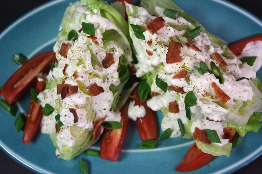 Blue Cheese Wedge Salad on a blue plate.