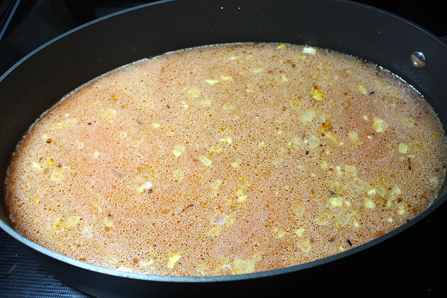 Mexican Rice stock and spices added to skillet