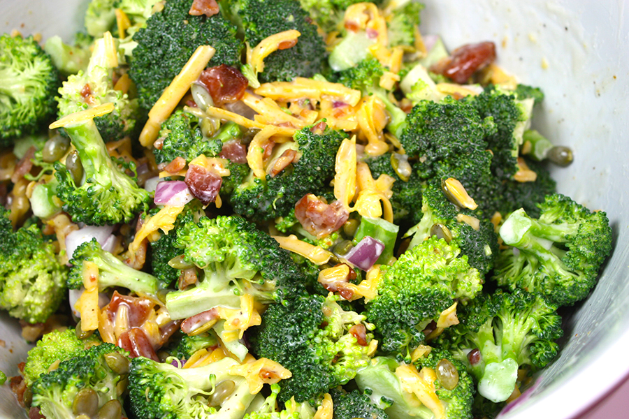 Broccoli salad in a white bowl.