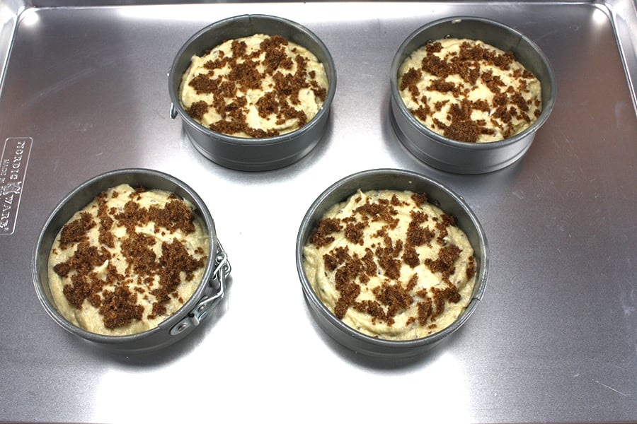 Seed Cake batter in small springform pans topped with brown sugar 