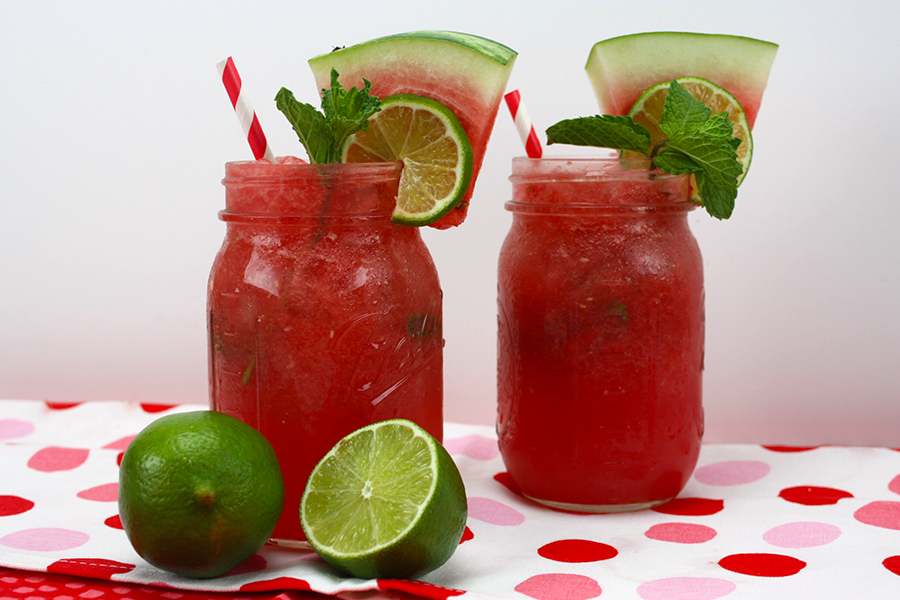 Watermelon Mojitos served in large mason jars.