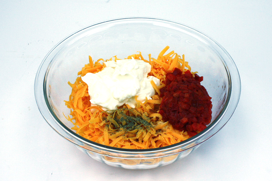 Pimento Cheese ingredients in a glass mixing bowl.