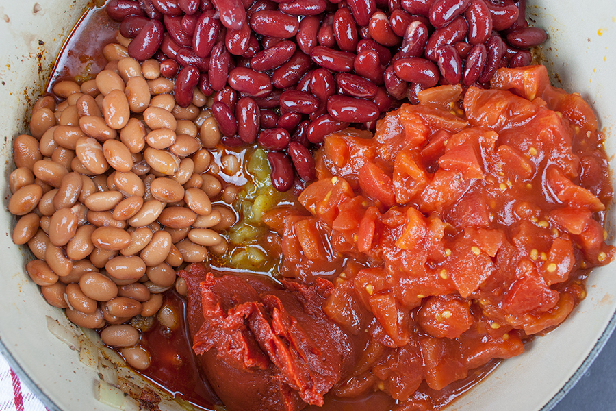 Thick & Hearty Homestyle Chili - beans, tomatoes, tomato paste, and chilis added to the dutch oven