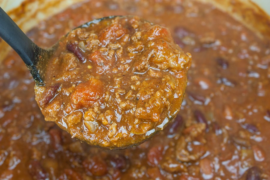 Thick & Hearty Homestyle Chili scooped in a ladle