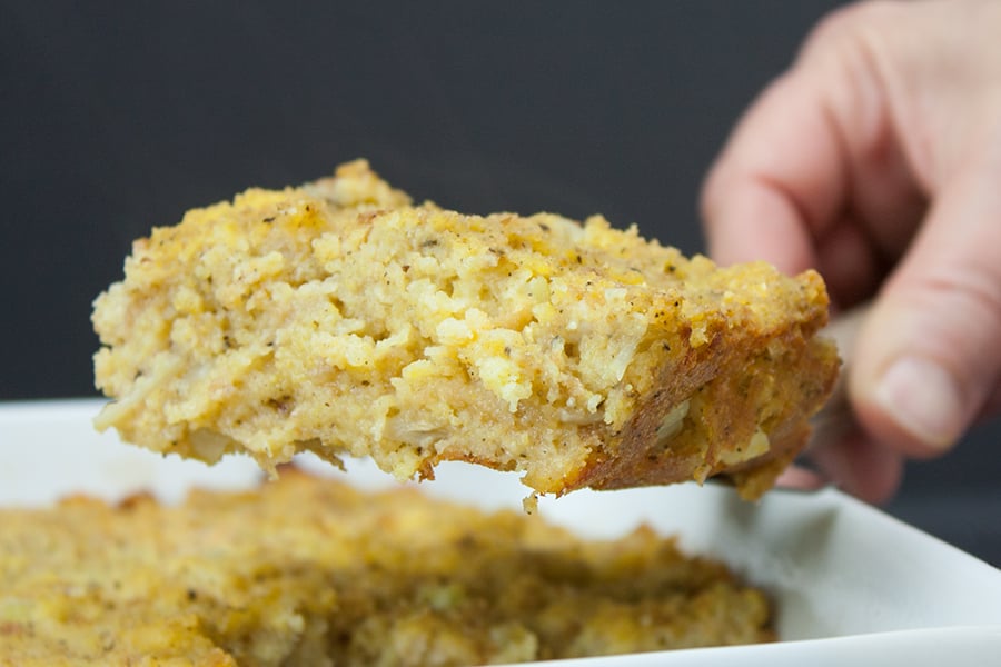 Southern Cornbread Dressing serving slice held up by spatula