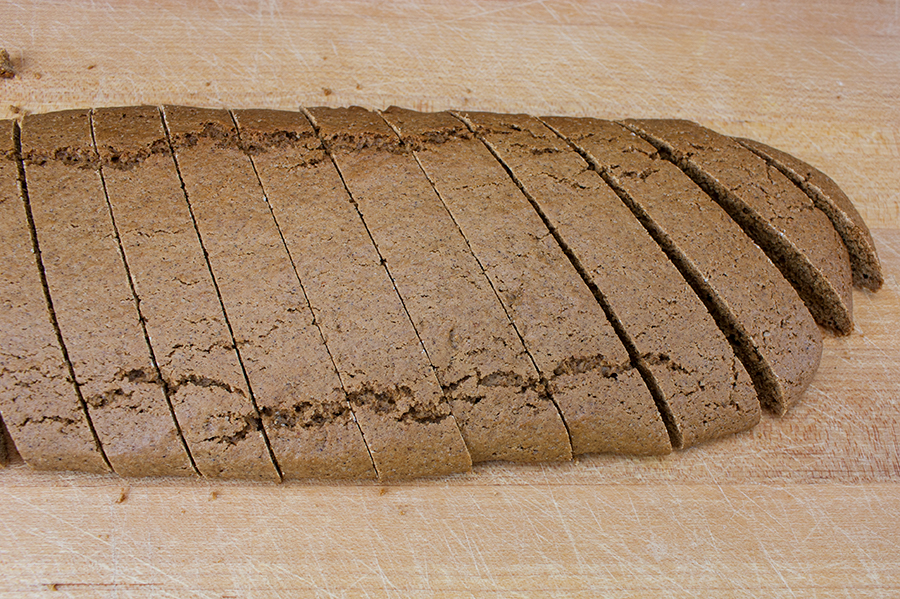 Gingerbread Biscotti sliced on a wooden cutting board.