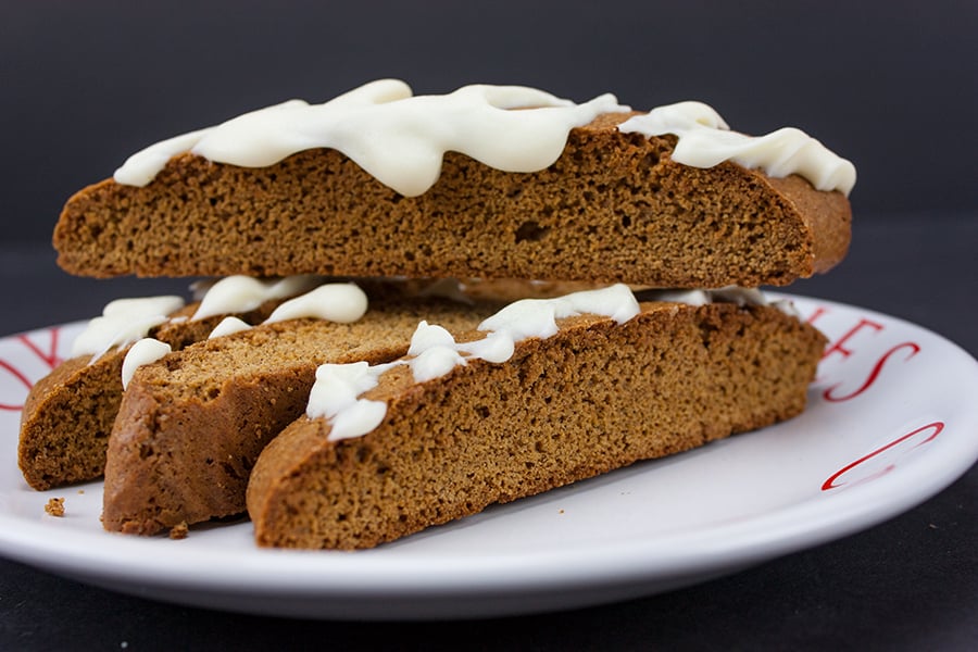 Gingerbread Biscotti stacked on a white plate.