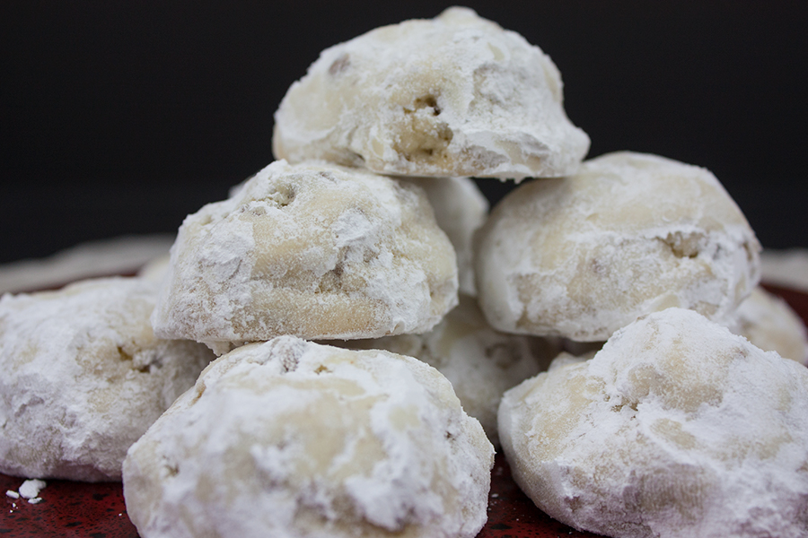 Italian Butterball Cookies stacked on a red plate.