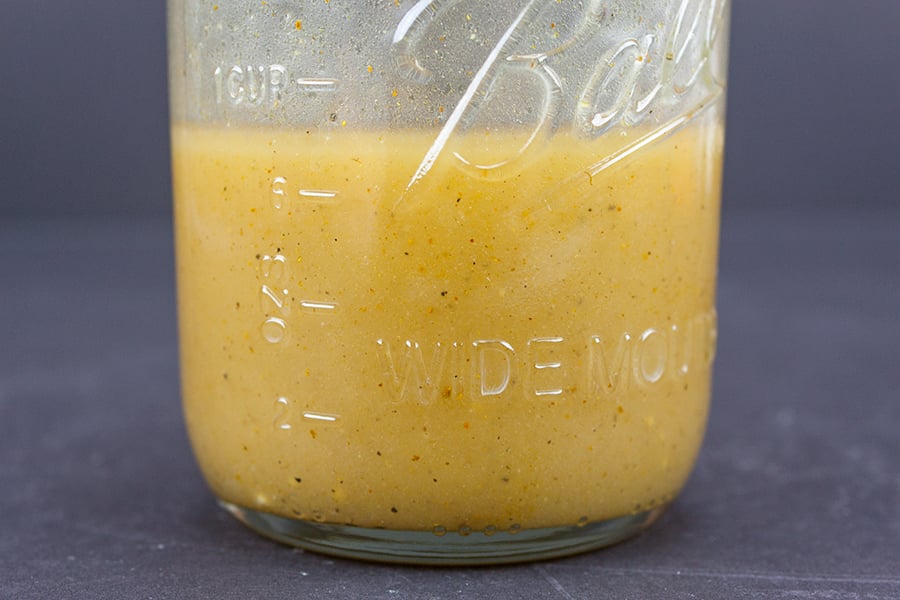 Spinach Salad with Curry Mustard Vinaigrette - vinaigrette mixed in a mason jar