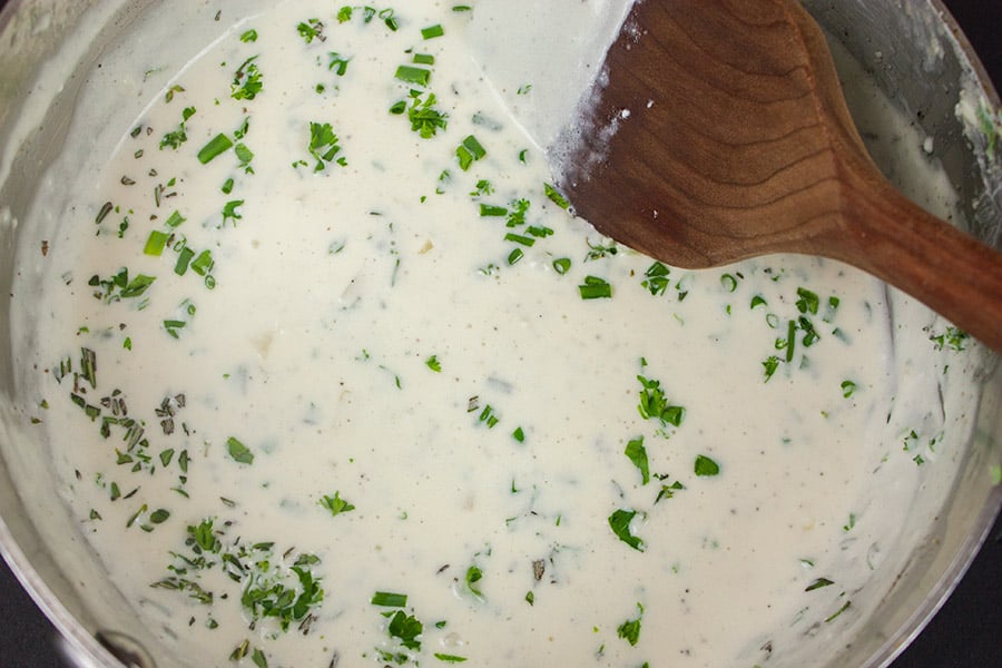 Creamy Herb Potatoes Gratin sauce in a saucepan