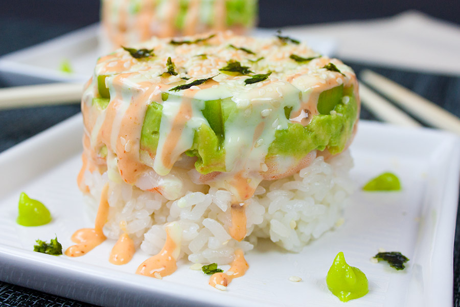 Spicy Shrimp Sushi Stack  on a white plate with garnish.