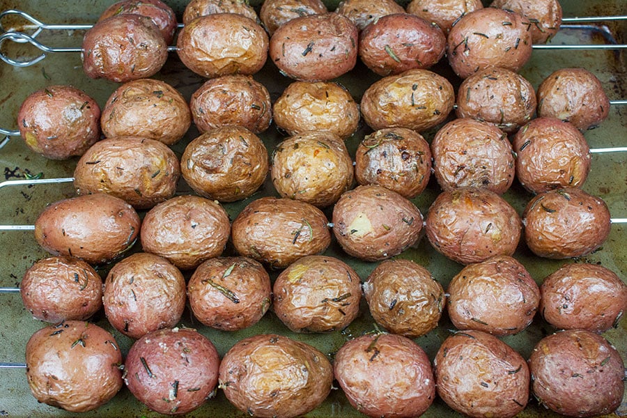 Rosemary Garlic Grilled Baby Potato Skewers on a baking sheet