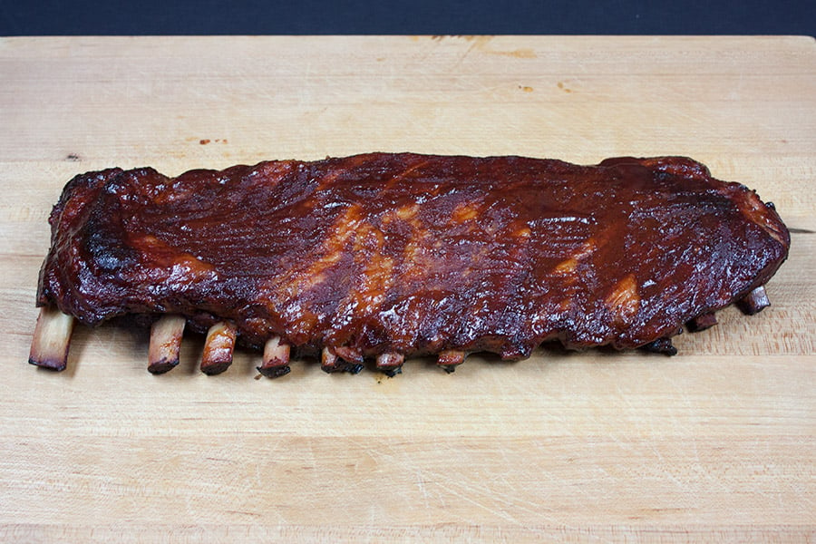 St Louis Style Ribs on a wooden cutting board.