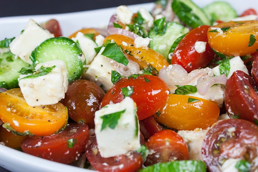 closeup of the Tomato Cucumber Feta Salad in a white serving bowl