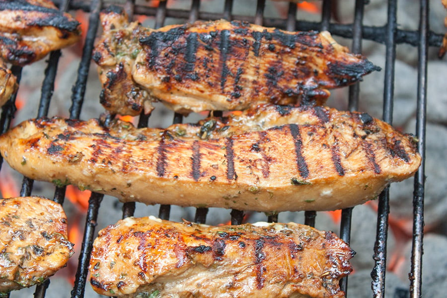 Grilled Chicken Marinade - marinated chicken pieces cooking on the grill