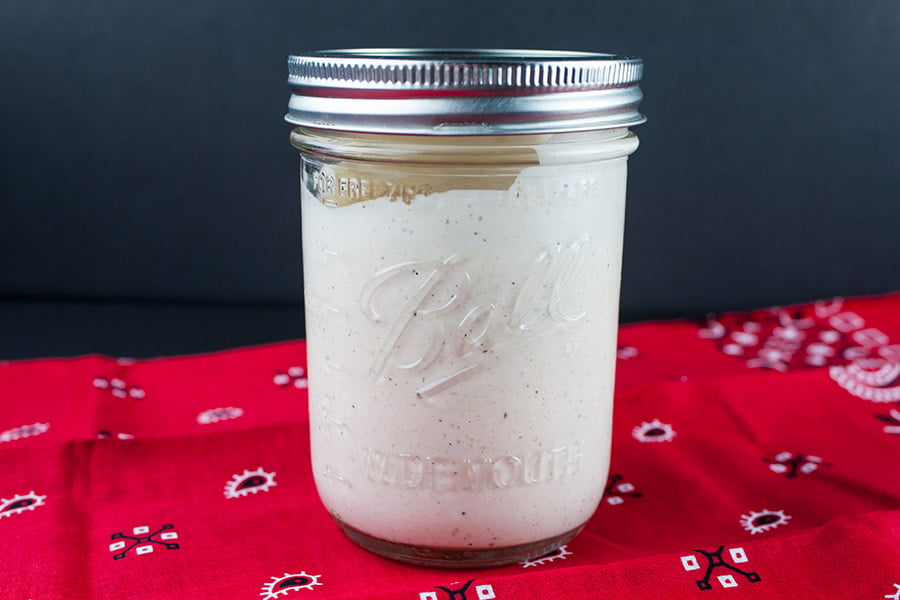 Alabama White BBQ Sauce in mason jar on a red bandana.