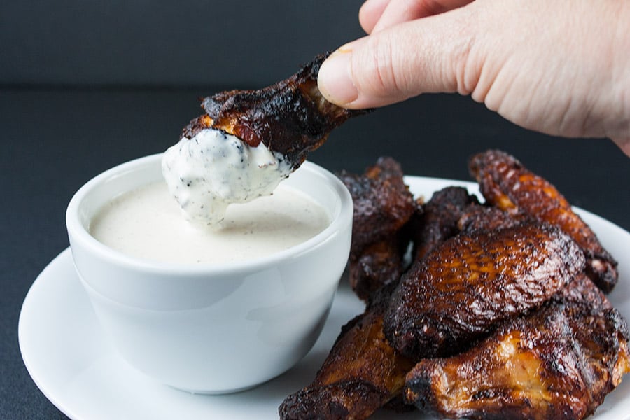 smoked chicken wing dipped in the Alabama white bbq sauce