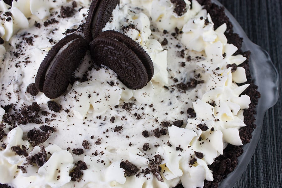 No Bake Cookies and Cream Pie garnished with whipped cream stars and crushed cookies