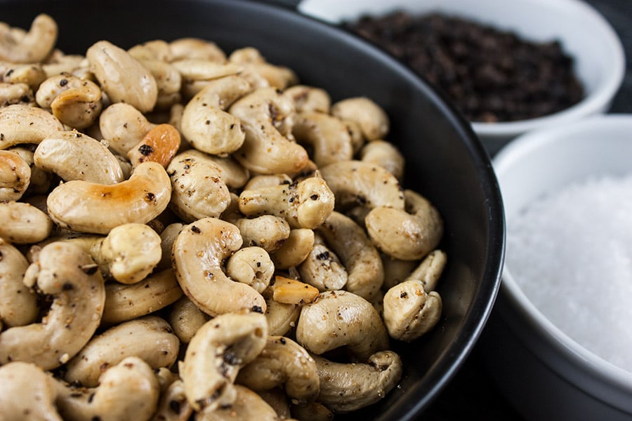 Salt and Pepper Roasted Cashews in a dark bowl.