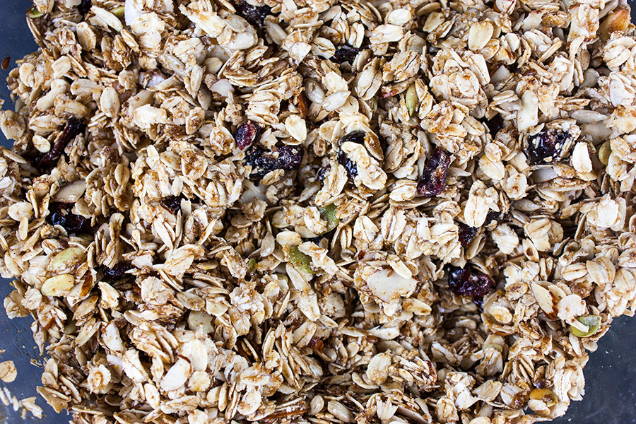 Granola bar ingredients mixed in a glass mixing bowl.