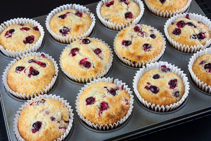 Baked cranberry orange muffins in a muffin tin.