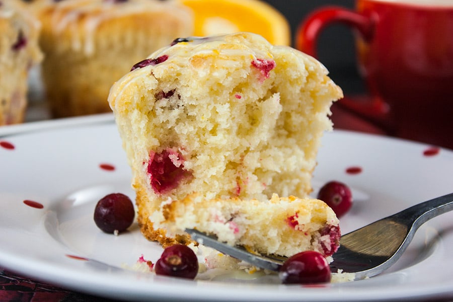 baked Cranberry Orange Muffin on white plate with fork