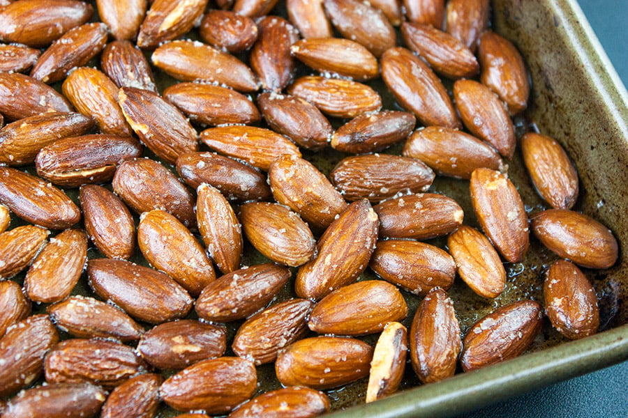Roasted salted almonds on sheet pan.