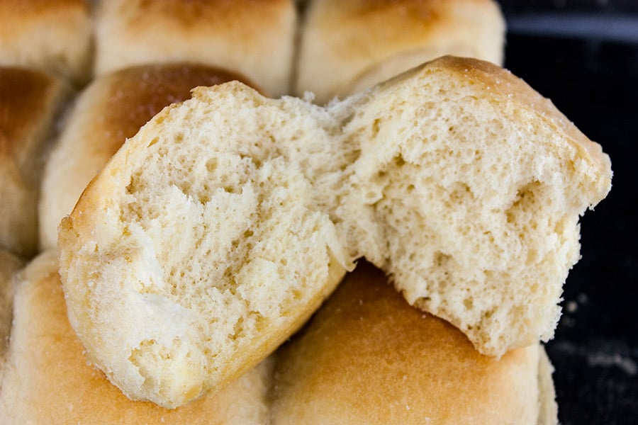  Dinner Rolls in the baking pan one on top cut open